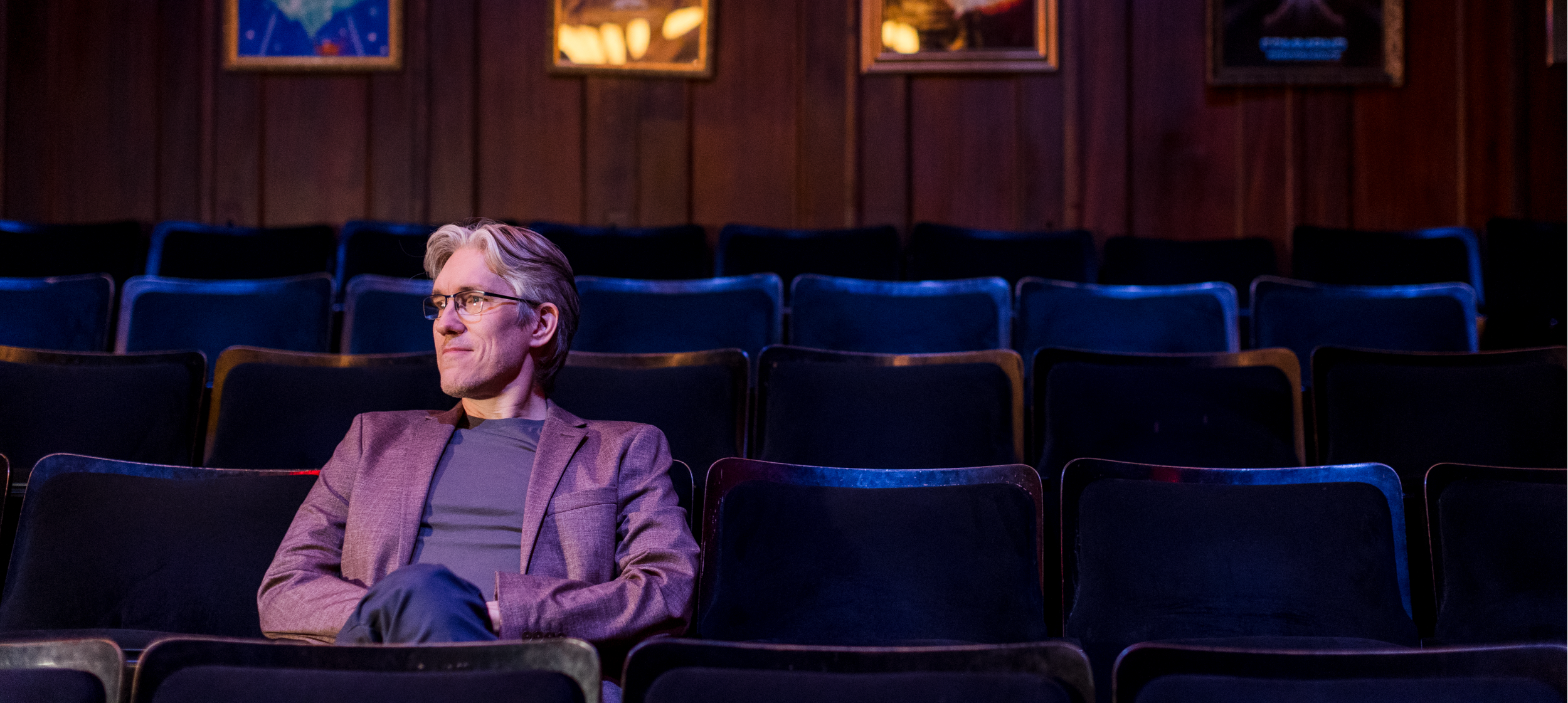 Chris Canfield seated in a theatre